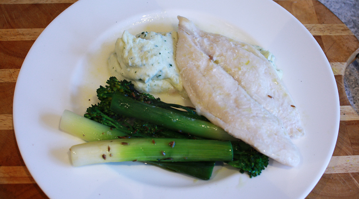 White fish ‘al cartoccio’ with cauliflower puree and roasted baby leeks
